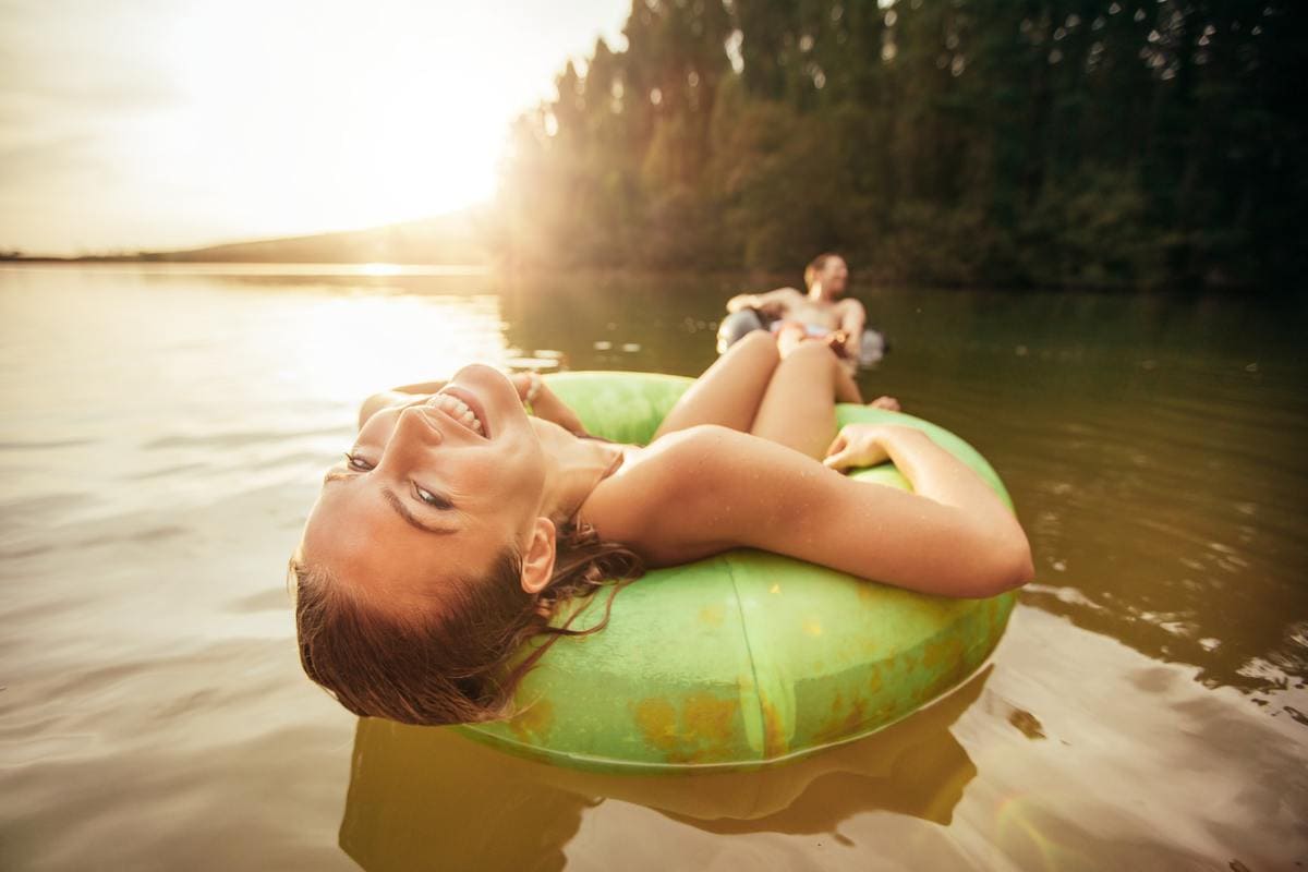 Young woman relaxing on inner tube in water