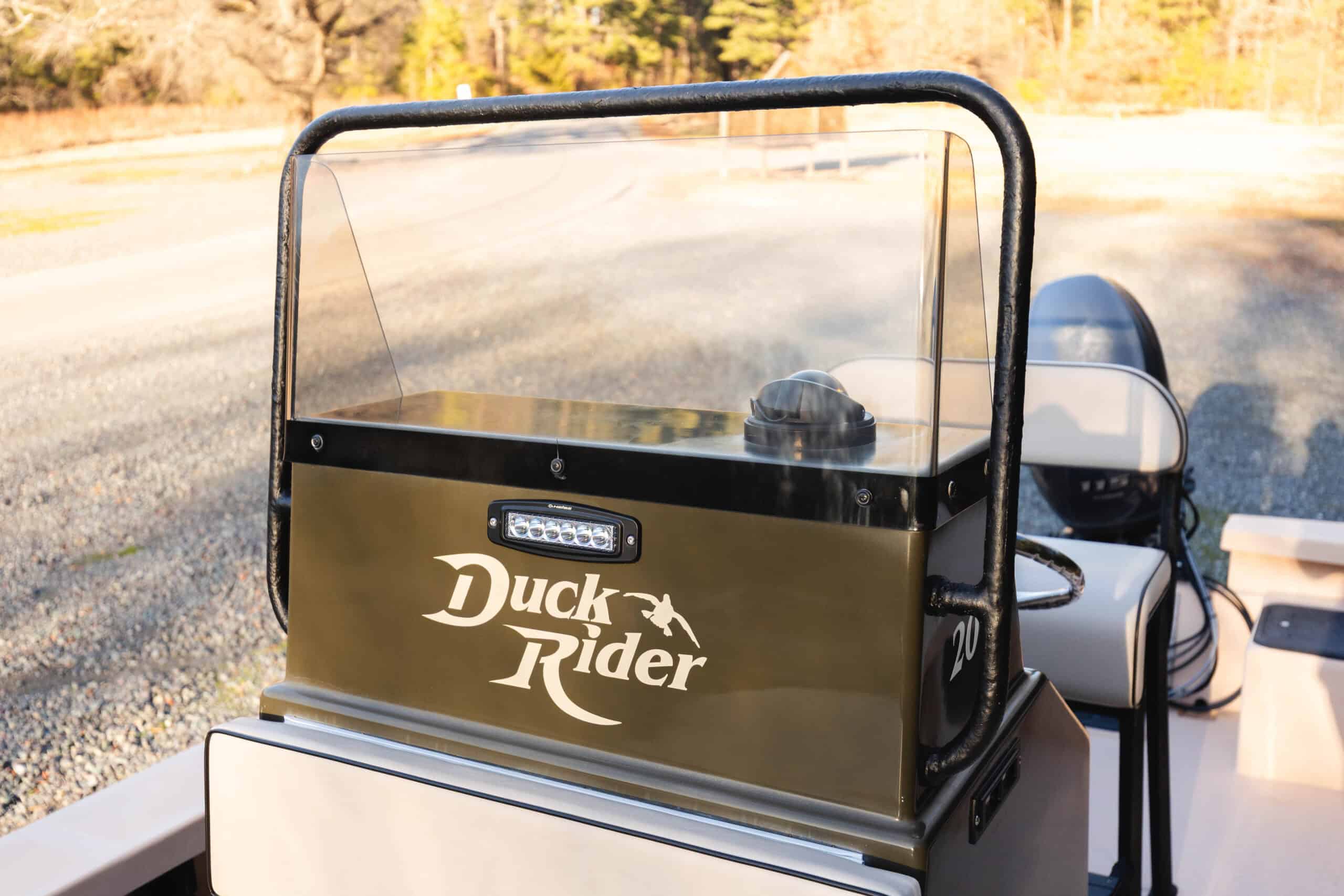 photo of a Duck Rider boat with logo and new LED spot light on the center console of the Bay Rider skiff